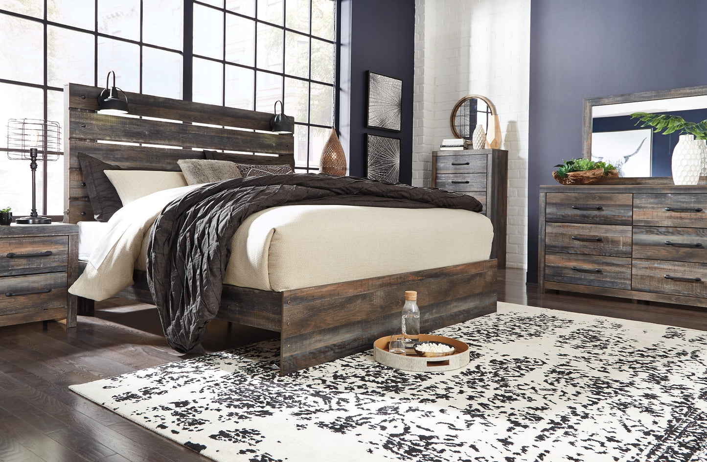 Drystan King Panel Bed with Mirrored Dresser, Chest and Nightstand at Walker Mattress and Furniture Locations in Cedar Park and Belton TX.
