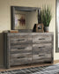 Wynnlow Queen Crossbuck Panel Bed with Mirrored Dresser, Chest and Nightstand at Walker Mattress and Furniture Locations in Cedar Park and Belton TX.