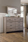 Zelen King Panel Bed with Mirrored Dresser and Chest at Walker Mattress and Furniture Locations in Cedar Park and Belton TX.