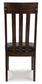 The Haddigan Dining Uph Side Chair (2/CN) features a dark brown finish, vertical slat backrest, and black faux leather upholstered seat, shown from the back.