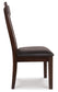 Side view of the Haddigan Dining UPH Side Chair (2/CN) featuring a dark brown wooden finish and a black cushioned upholstered seat, shown against a white background.