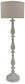 The Bernadate Poly Floor Lamp features a textured, carved wooden base with a whitewash finish and a large round beige fabric shade, elegantly designed in a candlestick style.