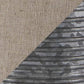 Diagonal split image features beige woven fabric texture on the top left and corrugated gray metal surface—evoking the design of the Norbert Metal Table Lamp (2/CN)—on the bottom right.
