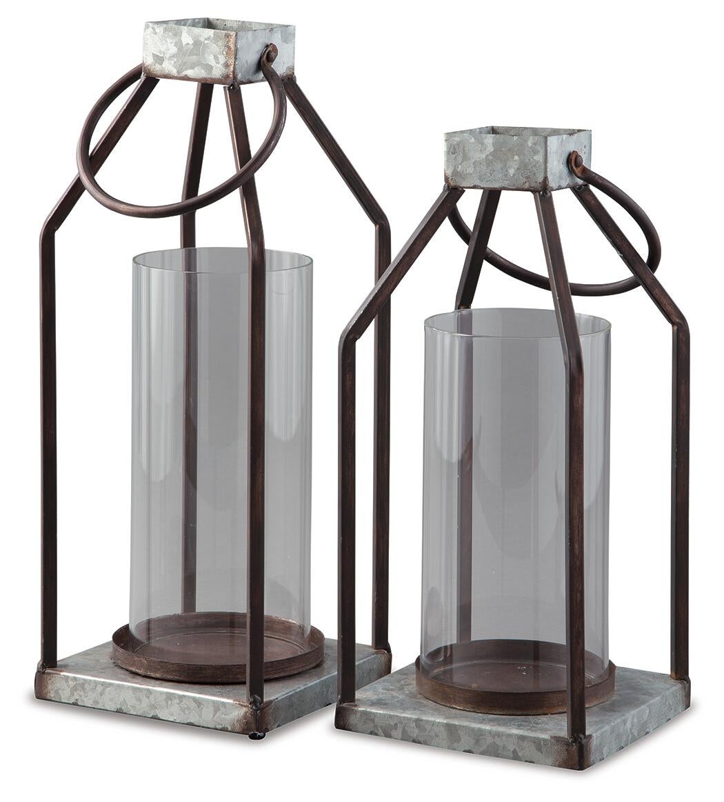 The Diedrick Lantern Set (2/CN) features two galvanized metal and glass candle holders with cylindrical glass inserts and square bases, ideal for indoor or outdoor use, displayed side by side against a white background.