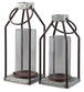 The Diedrick Lantern Set (2/CN) features two galvanized metal and glass candle holders with cylindrical glass inserts and square bases, ideal for indoor or outdoor use, displayed side by side against a white background.
