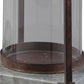 A close-up of the Diedrick Lantern Set (2/CN) base shows its galvanized metal, supporting rod, and metal rim, resting on a stone surface.