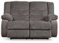 The Tulen Reclining Loveseat, shown from the front against a white background, features a large gray chenille fabric design with padded armrests, a plush backrest, and dual-sided recliner functionality.