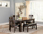 A dining room with a Haddigan RECT Dining Room EXT Table featuring a butterfly leaf, four matching chairs, a bench, a fruit bowl, drinks tray, abstract wall art, and a large window with light curtains.