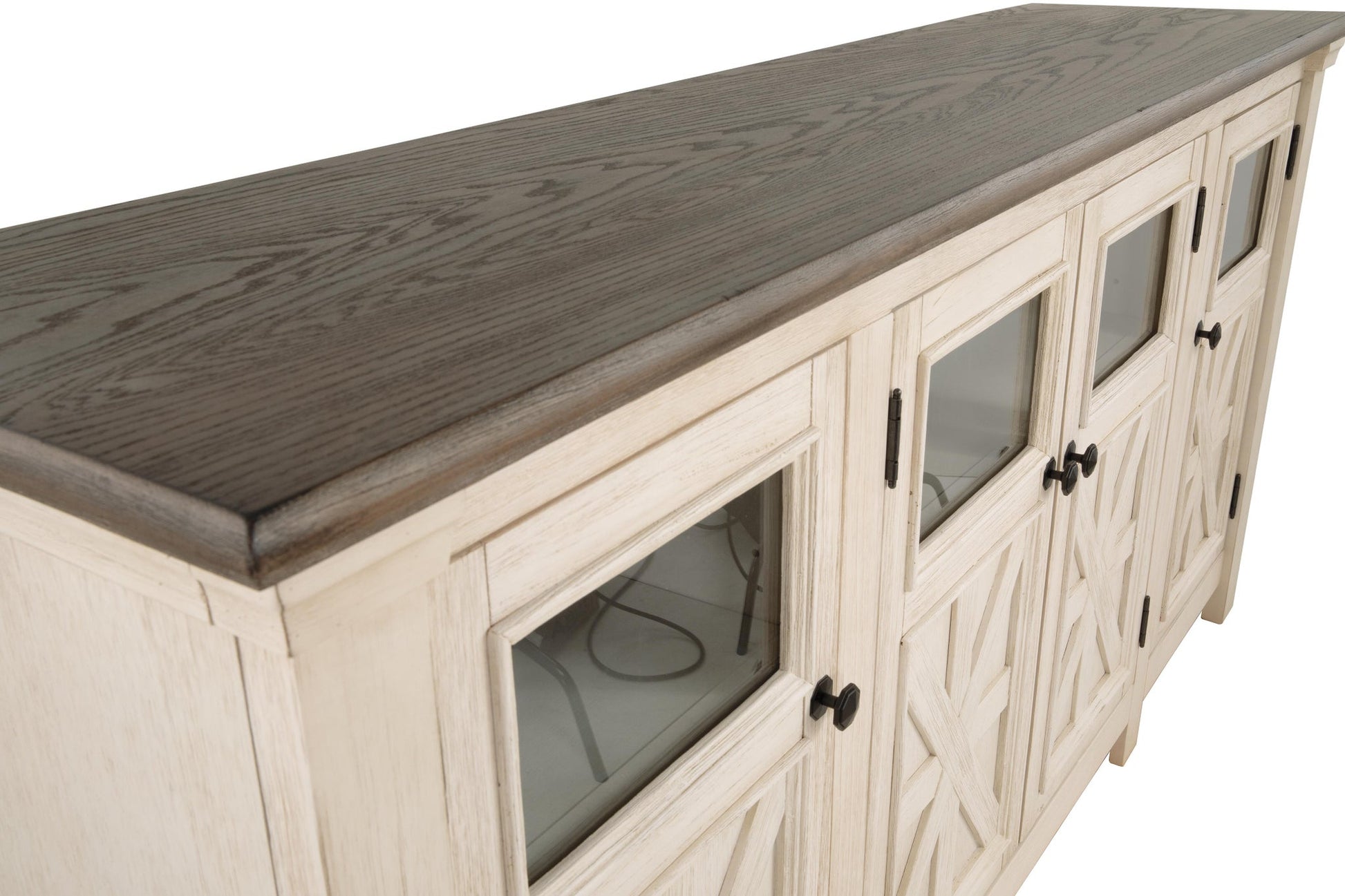 The Bolanburg Extra Large TV Stand features a light wood frame and dark wood top, glass-front cabinet doors, and black handles, combining rustic farmhouse charm with modern style for your living space.