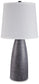 The Shavontae Poly Table Lamp (2/CN) features a modern textured dark gray resin base and a clean white fabric shade, perfect for contemporary spaces.