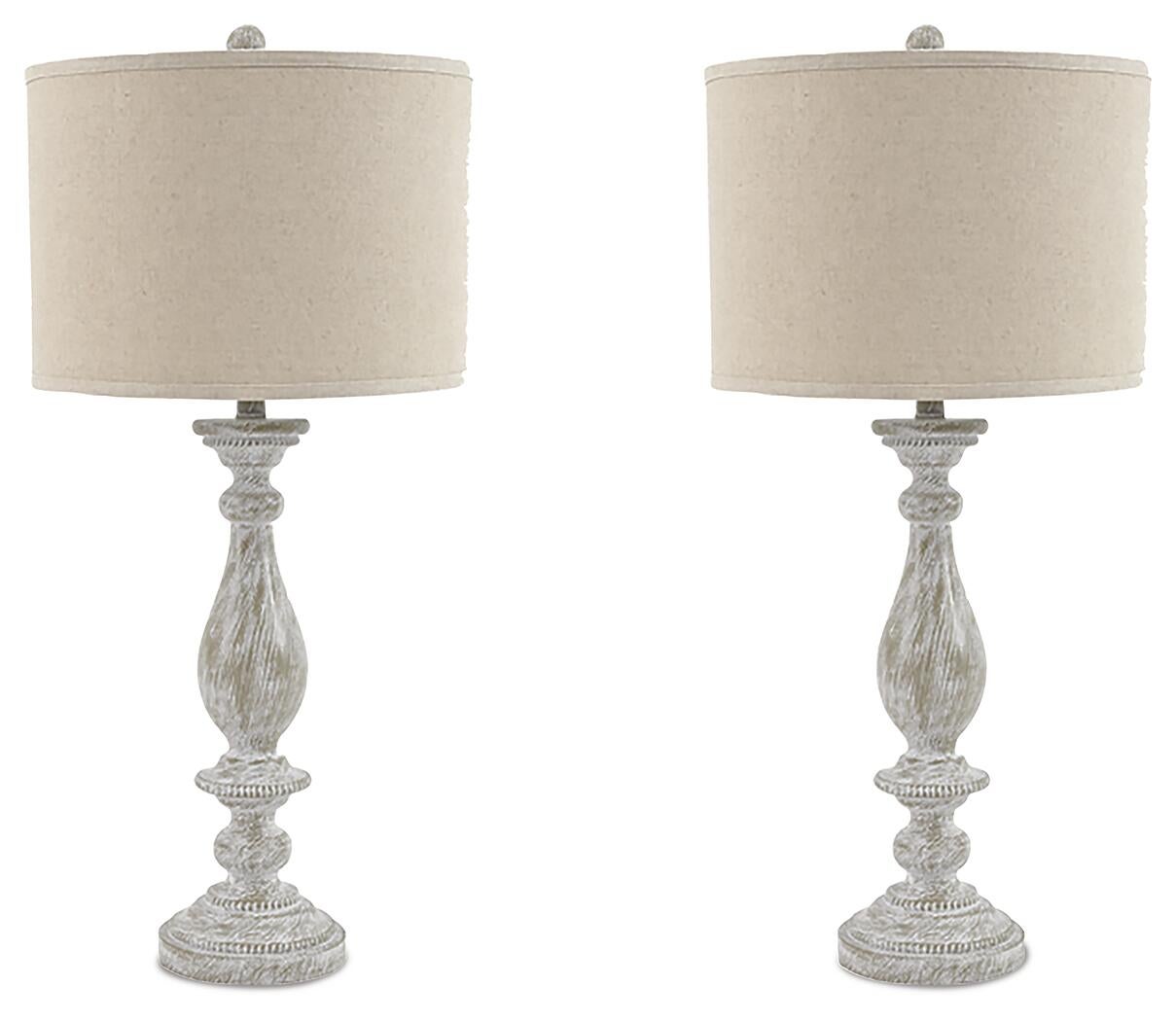 A pair of Bernadate Poly Table Lamps (2/CN) with beige drum shades and ornate candlestick-style bases in a distressed whitewash finish, displayed side by side against a white background.