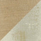 A diagonal split image shows coarse brown fabric on the upper left and the cracked, aged white surface of the Emelda Ceramic Table Lamp (1/CN) on the lower right, evoking a vintage aesthetic.