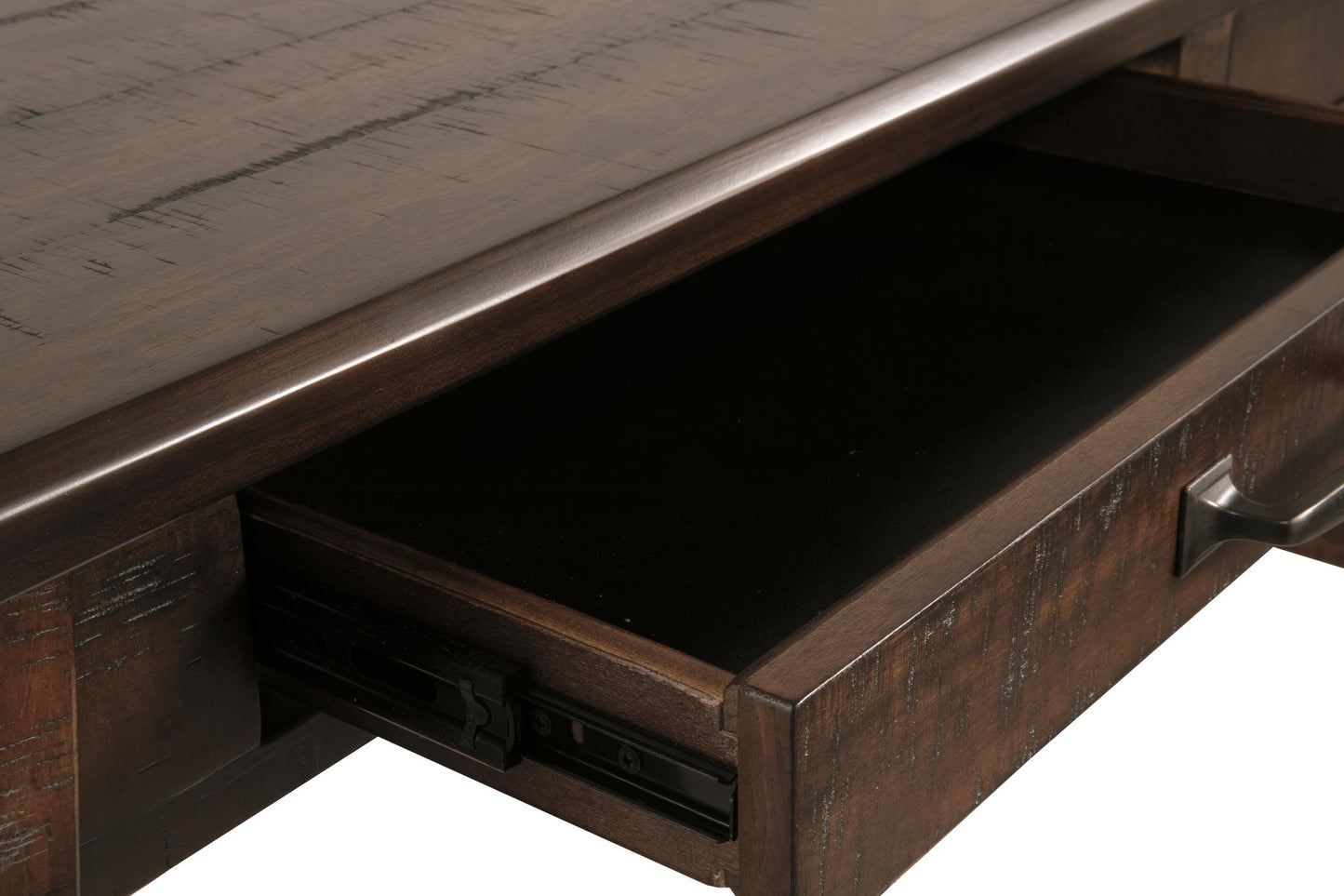 A close-up of an open drawer with metal handles on the Baldridge Home Office Large Leg Desk, revealing the dark interior and a portion of the desk’s rustic industrial surface above.