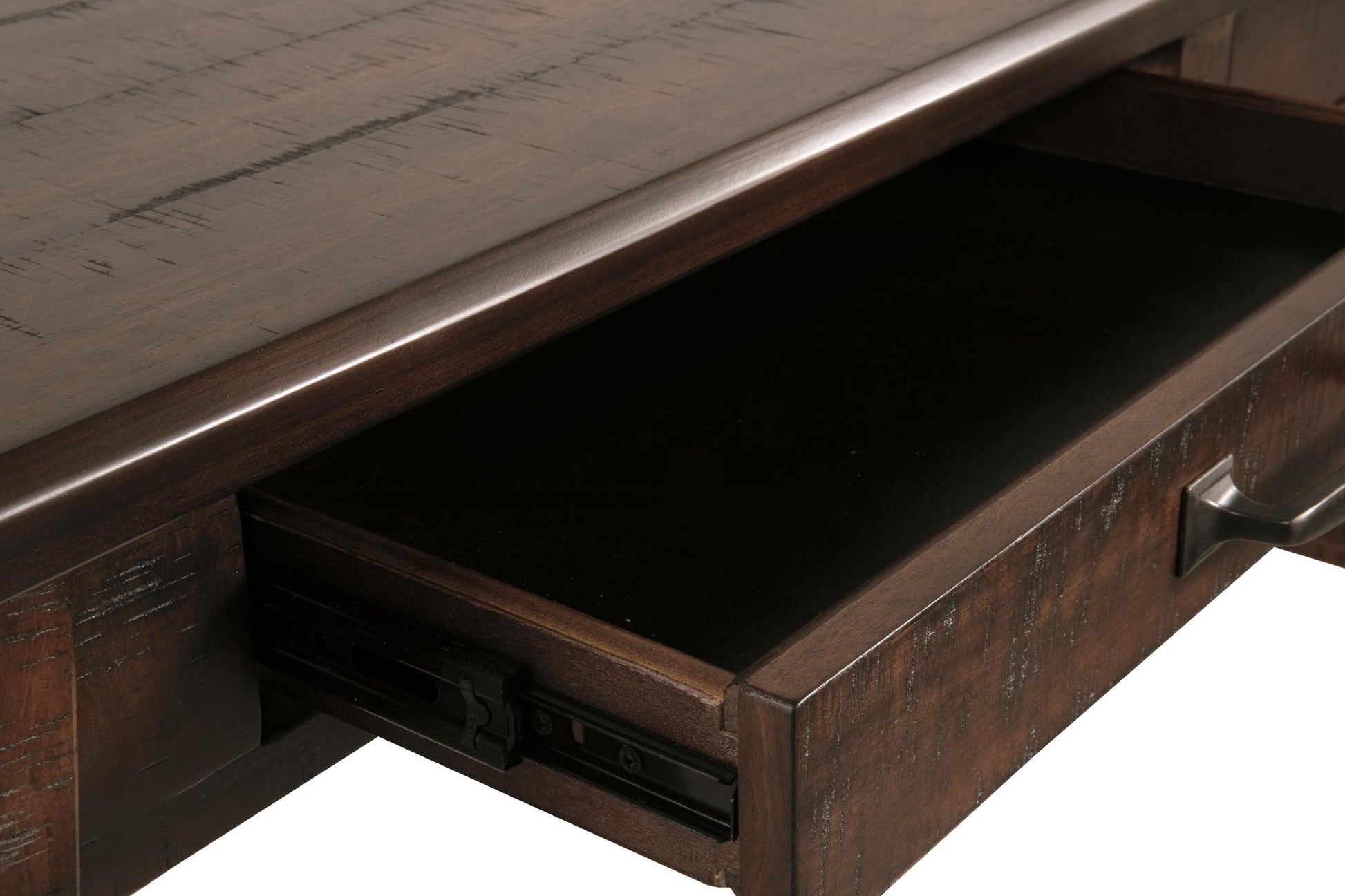 A close-up of an open drawer with metal handles on the Baldridge Home Office Large Leg Desk, revealing the dark interior and a portion of the desk’s rustic industrial surface above.