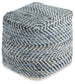 The Chevron Pouf is a square, handmade ottoman with a woven blue and white zigzag pattern that adds style to any space.