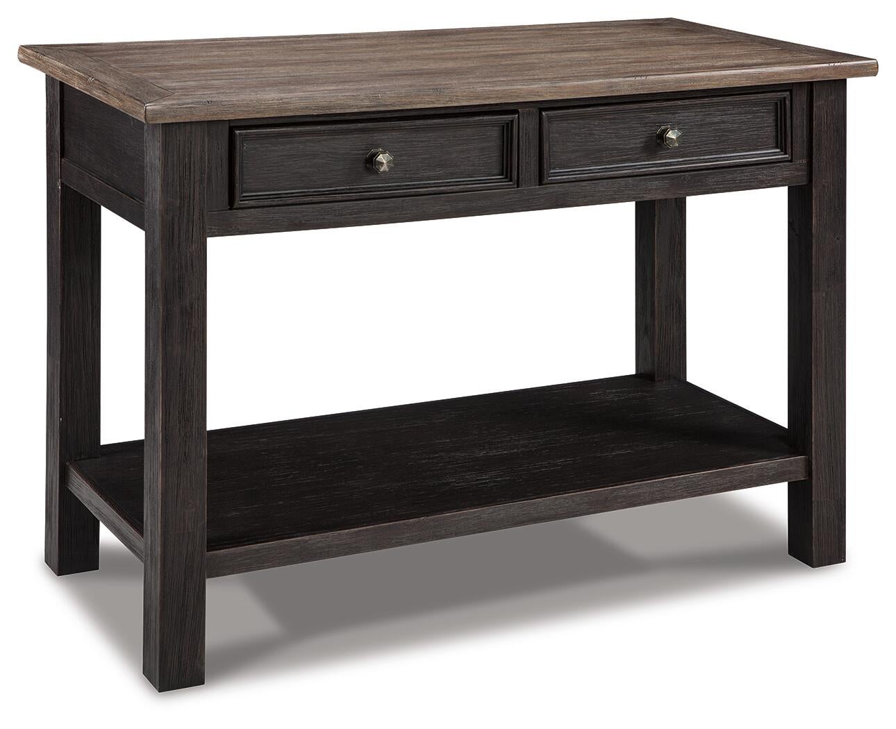 The Tyler Creek Sofa Table features a weathered gray-brown wood top, two drawers with classic hardware knobs, and a lower shelf for storage in a shabby chic style.