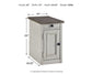 The Bolanburg Chair Side End Table, in antique white finish, features a drawer and door for storage. Dimensions: 23" H x 14" W x 24.25" D; weight: 42 lbs.
