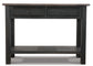The Tyler Creek Sofa Table features a black wooden finish, traditional hardware, two small drawers, and a lower shelf, displayed against a white background.