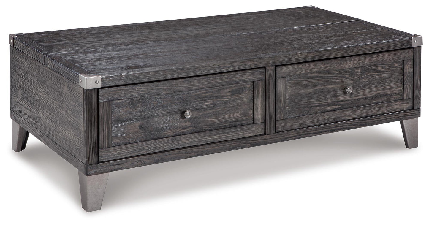 The Todoe Lift Top Cocktail Table features a rectangular design with a dark finish, metal corner accents, two drawers, and angled legs—blending rustic-industrial style and function in one striking piece.