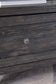 Close-up of a dark wooden drawer with a round metal knob on the Todoe Lift Top Cocktail Table, with part of a textured rug visible underneath.