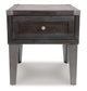 The Todoe Rectangular End Table features a contemporary rustic-industrial style with dark wood and metal, a single front drawer, and four straight legs.