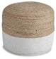 The Sweed Valley Pouf features a round shape with natural jute fibers woven on the top half and white fabric on the bottom, adding rustic charm to any space. Displayed on a white background.