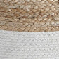Close-up of the Sweed Valley Pouf, a woven basket-style pouf with natural tan fibers on top and white fibers on the bottom.