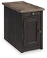 The Tyler Creek Chair Side End Table features a weathered gray-brown finish, metal knobs, a drawer and cabinet door, a rectangular shape, and a built-in charging station for convenient device charging.