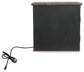 The Tyler Creek Chair Side End Table features a weathered gray-brown rectangular wood design with a closed lid and a black electrical cord extending from the side, serving as a stylish compact table with built-in charging capabilities.