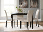 A modern dining room featuring the Kimonte Rectangular Dining Room Table in dark brown, four beige upholstered chairs, a white vase with greenery, glassware, and two abstract paintings on a gray wall.