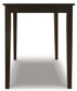 The Kimonte Rectangular Dining Room Table features a plain, dark brown finish and four straight legs, shown front-facing against a white background—ideal for contemporary spaces or as a compact dining table.