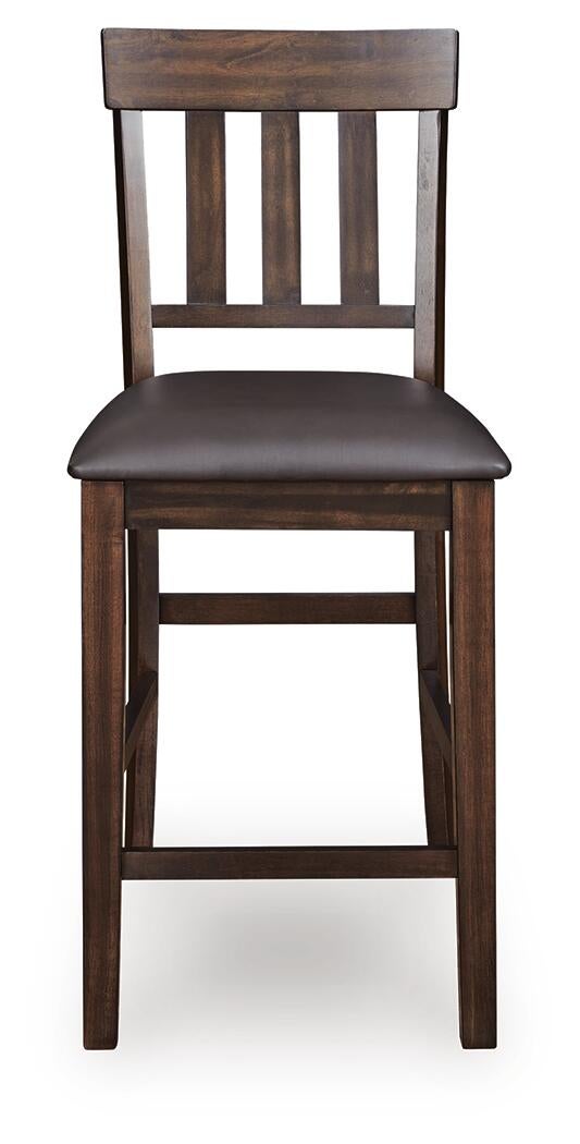 The Haddigan Upholstered Barstool (2/CN) features a dark wood finish, a slat back design, and a cushioned faux leather seat.
