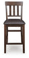 The Haddigan Upholstered Barstool (2/CN) features a dark wood finish, a slat back design, and a cushioned faux leather seat.