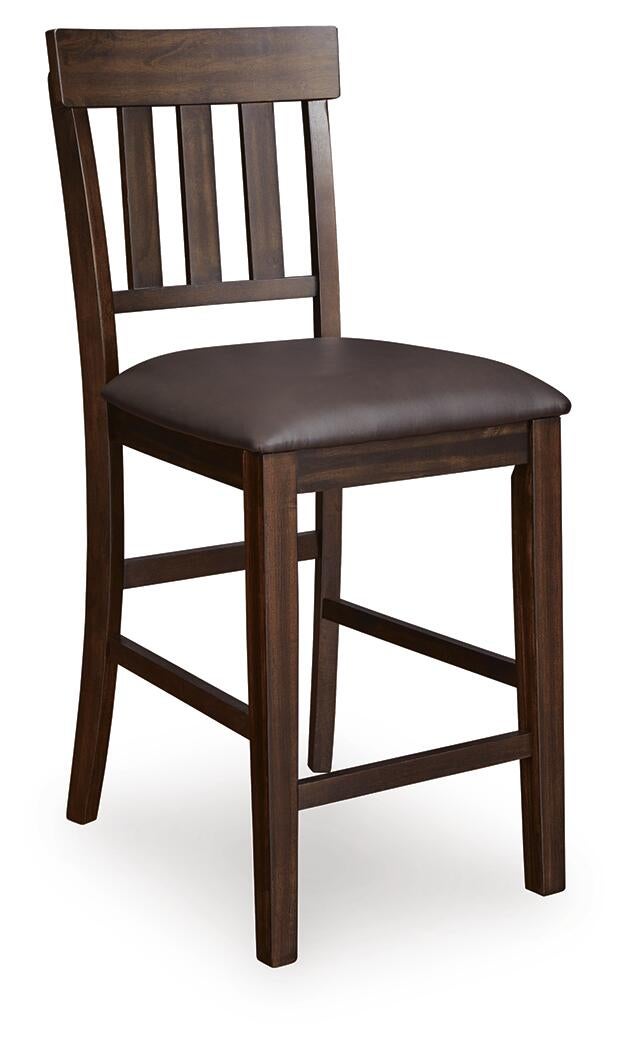The Haddigan Upholstered Barstool (2/CN) features a classic slat back design and a dark brown faux leather seat for comfort.