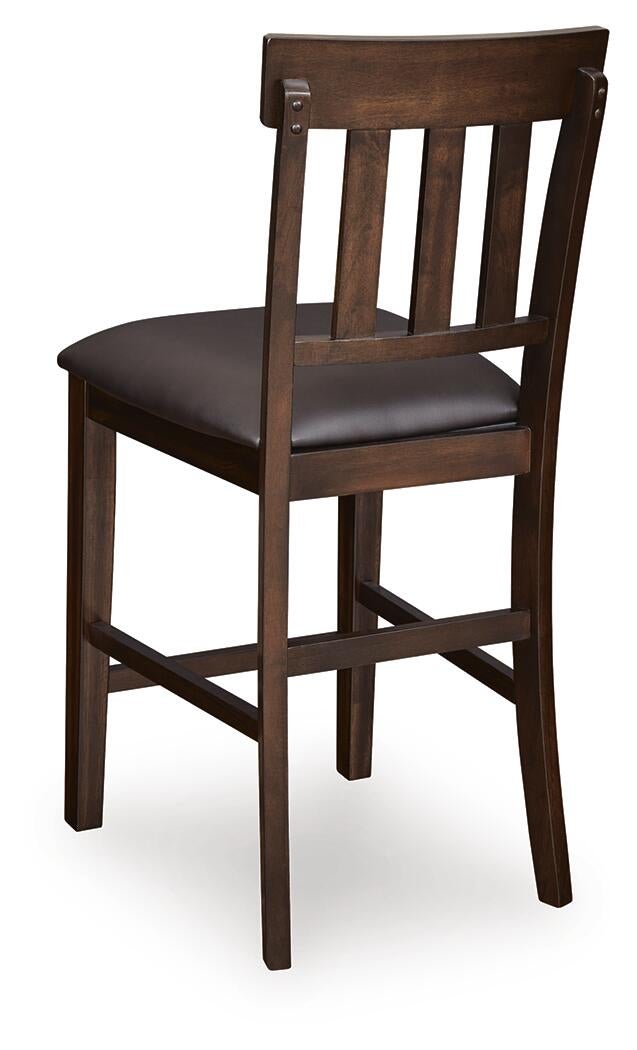The Haddigan Upholstered Barstool (2/CN) features a dark-finished wooden frame, padded brown faux leather seat, classic slat back design, and a convenient footrest.