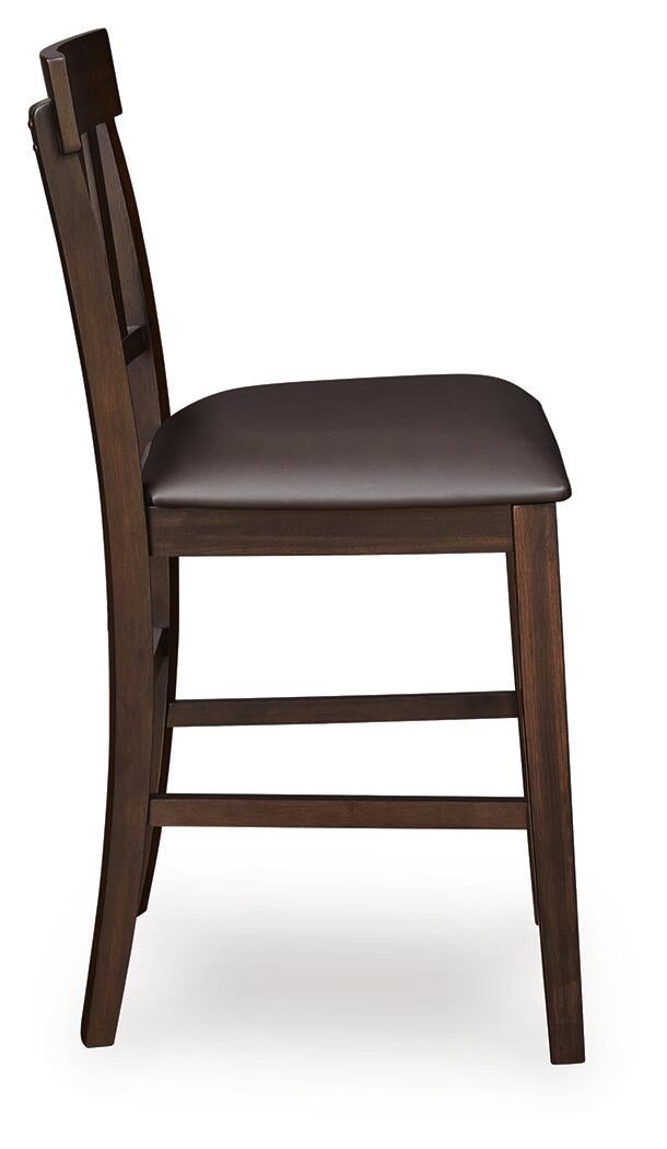 Side view of the Haddigan Upholstered Barstool (2/CN) featuring a dark brown wooden frame, slat back, cushioned faux leather seat, and convenient footrest.