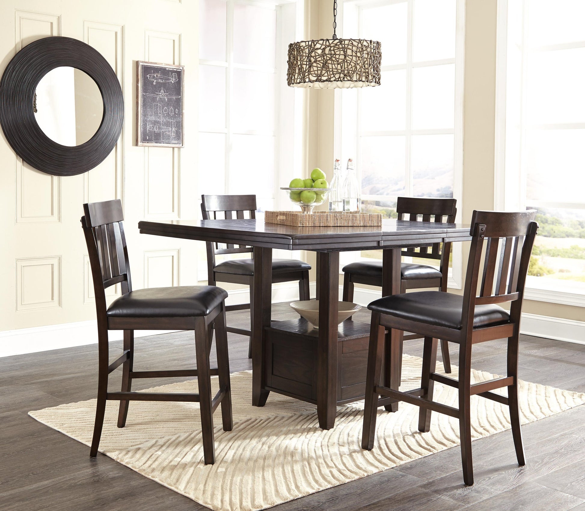 Two Haddigan Upholstered Barstools with slat backs are placed by a dark wood dining table on a light rug in a bright room with large windows, wall decor, and a woven hanging light fixture above the table.