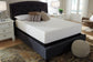 A neatly made bed features the Chime 12 Inch Memory Foam Mattress and several pillows, with two white nightstands and lamps on each side, set in a bright, well-lit bedroom.