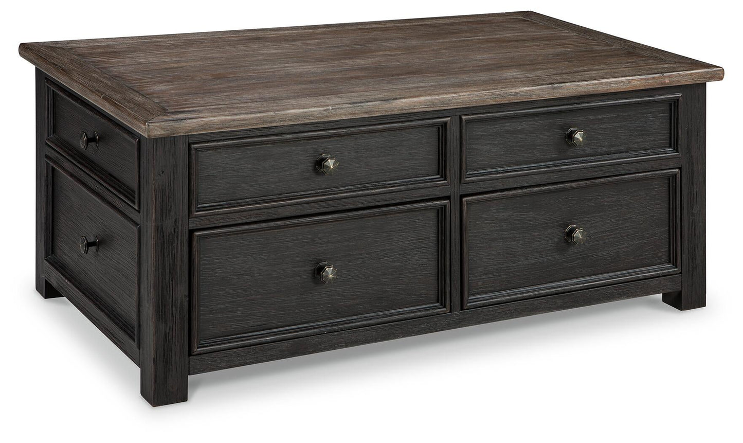 The Tyler Creek Lift Top Cocktail Table features a weathered rectangular top, four drawers with metal knobs, and dark wood sides—combining shabby chic style with practical storage for your living room.