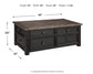 The Tyler Creek Lift Top Cocktail Table, shown in a dark finish, features four drawers for storage. Dimensions: 46"W x 26"D x 20"H; weight: 125 lbs. Perfect for organizing your living space with a blend of style and function.