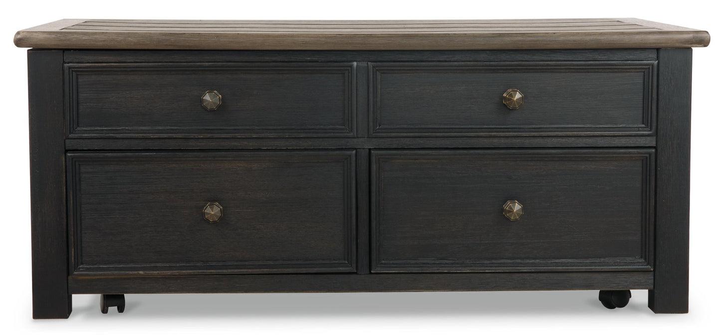 The Tyler Creek Lift Top Cocktail Table features a dark wood finish, four drawers with metal knobs, and small wheels—ideal as a stylish storage coffee table for your living room.
