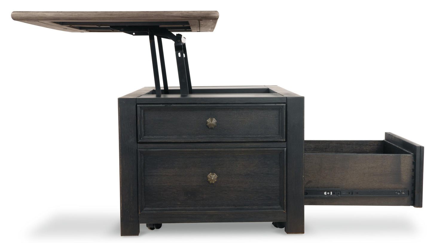 The Tyler Creek Lift Top Cocktail Table features a dark wood finish, a lift-top mechanism revealing interior storage, and a lower drawer that can be pulled out.