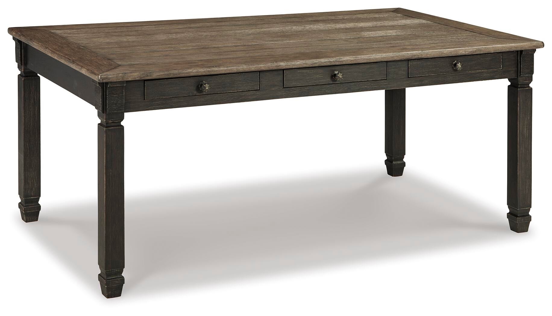 The Tyler Creek Rectangular Dining Room Table features a dark two-tone finish, four sturdy legs, and three small side drawers—ideal for urban farmhouse style spaces.