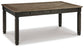 The Tyler Creek Rectangular Dining Room Table features a dark two-tone finish, four sturdy legs, and three small side drawers—ideal for urban farmhouse style spaces.
