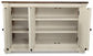 The Bolanburg Dining Room Server features a white wood frame, two open cabinet doors revealing three interior shelves, and a dark weathered oak finish top.