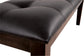 Close-up of the Haddigan Large UPH Dining Room Bench featuring a dark brown wood frame and a black tufted leather seat cushion.