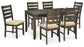 The Rokane Dining Room Table Set (7/CN) features a dark wood table with six matching chairs upholstered in light beige, all displayed on a white background.