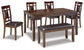The Bennox Dining Room Table Set (6/CN) includes a dark wood table, four upholstered chairs with square backrests, and a matching bench, all featuring padded dark brown seats.