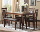 A modern dining room featuring the Bennox Dining Room Table Set (6/CN) with a dark wood table, four upholstered chairs, a bench with black cushions, and a decorative centerpiece on a geometric rug.