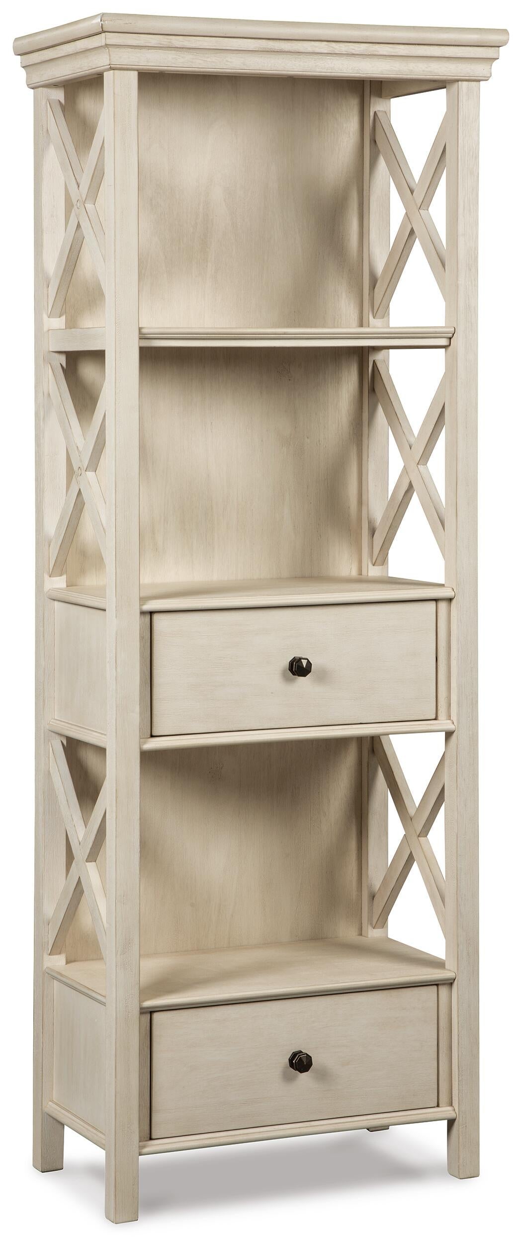 The Bolanburg Display Cabinet features an antiqued white finish, open sides with crisscross details, two shelves, and two drawers with round knobs—a charming cottage-style addition to your home.